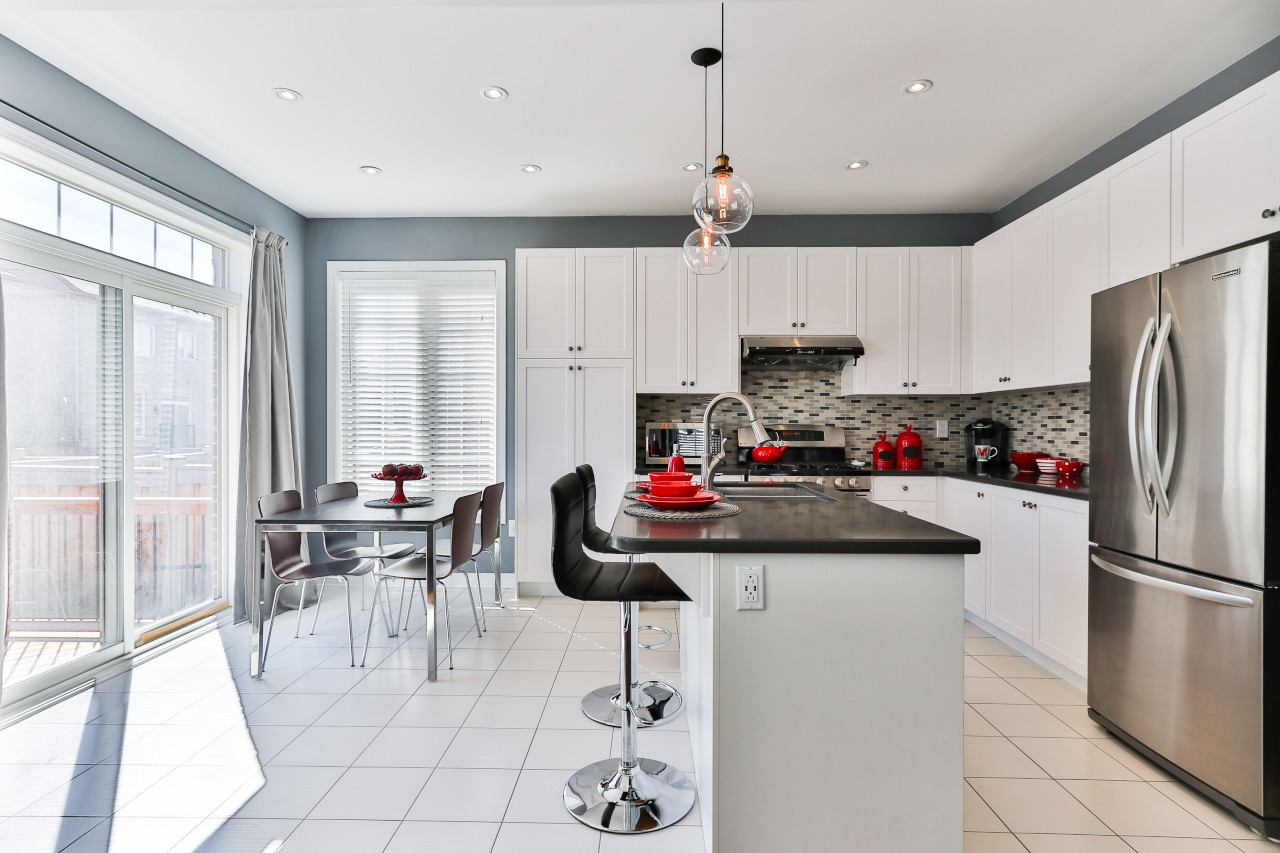 Black and White Kitchen With Red Accessories -- Photo Courtesy of Sidekix Media