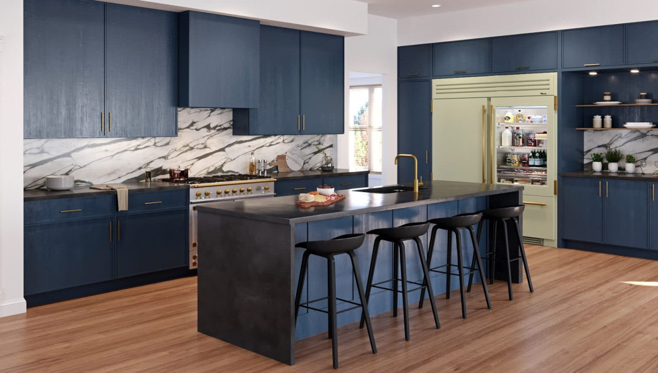 Pictured here, you can see two of 2024's top kitchen color trends: Navy blue and sage green are both trendy colors to decorate with in the kitchen.  Photo Courtesy of True Residential
