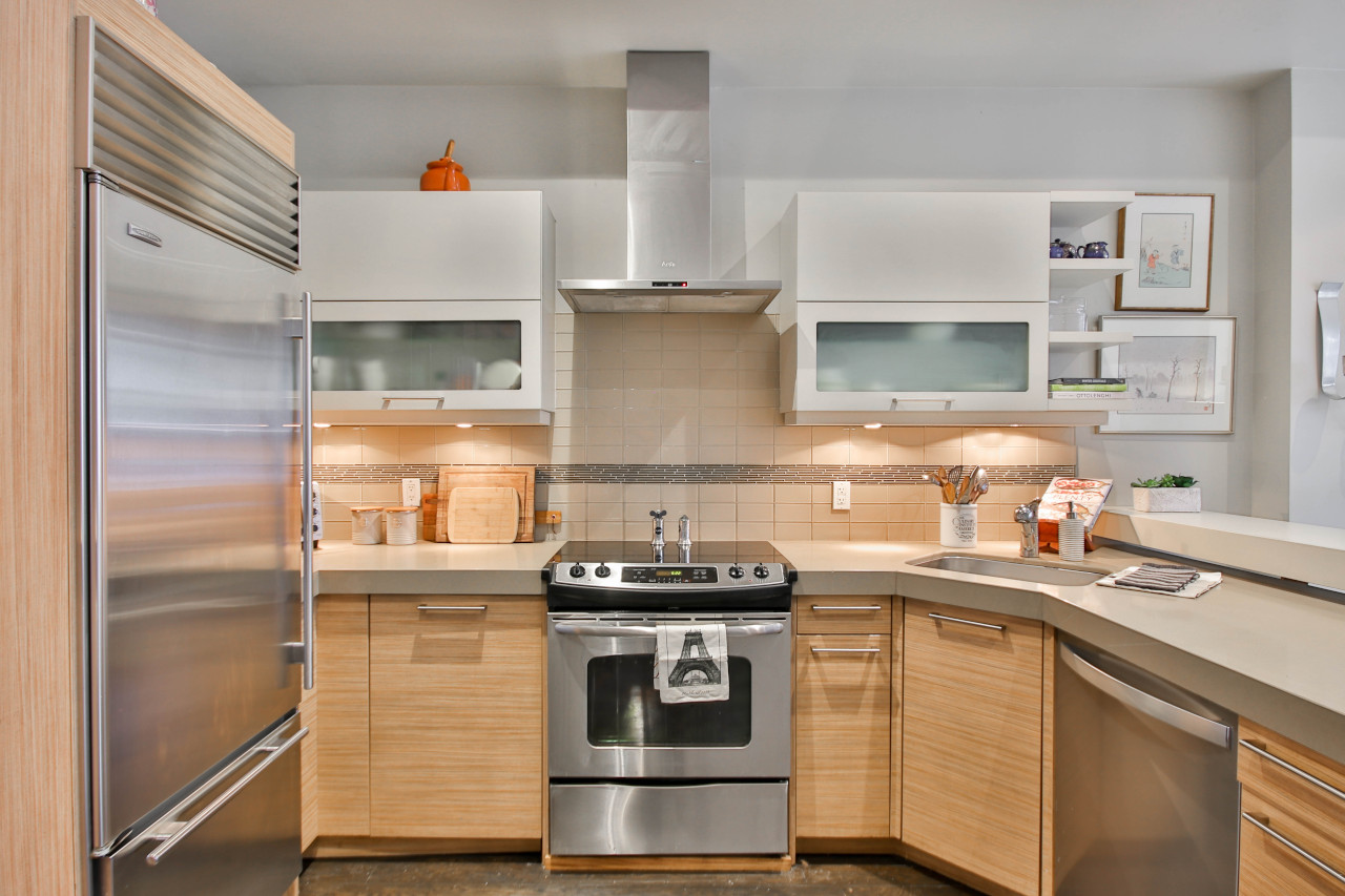 Kitchen With Warm Wood Tones + Stainless Steel Appliances -- Photo Courtesy of Sidekix Media
